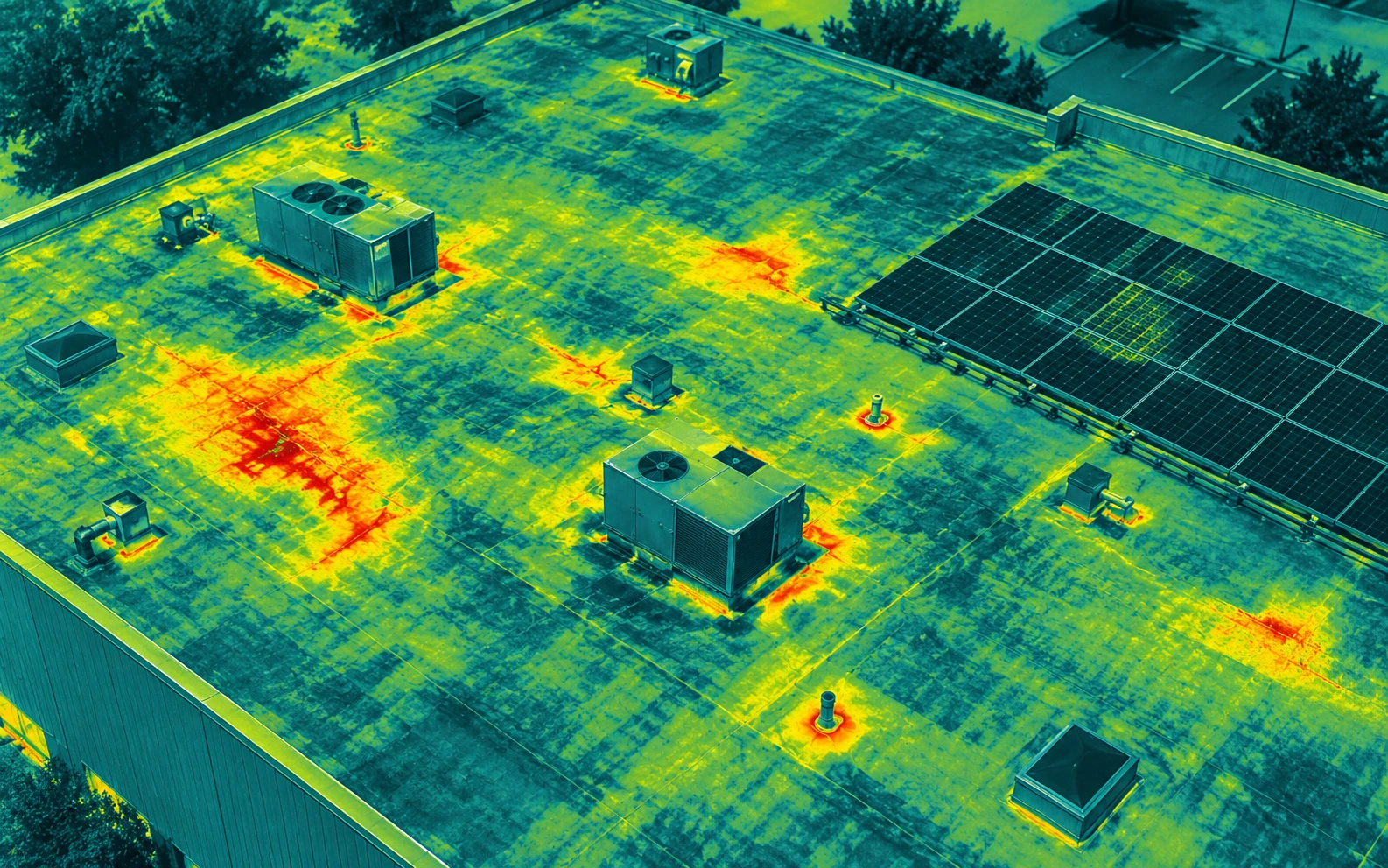 Drone thermal roof inspection showing rooftop HVAC units, roof moisture signatures, and a solar array with a flagged hot area